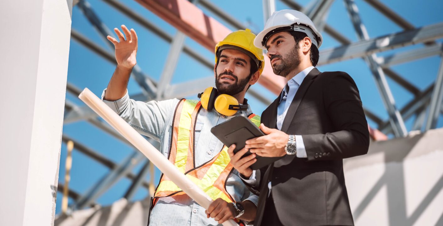 civil engineer construction worker manager holding digital tablet blueprints talking planing about construction site cooperation teamwork concept