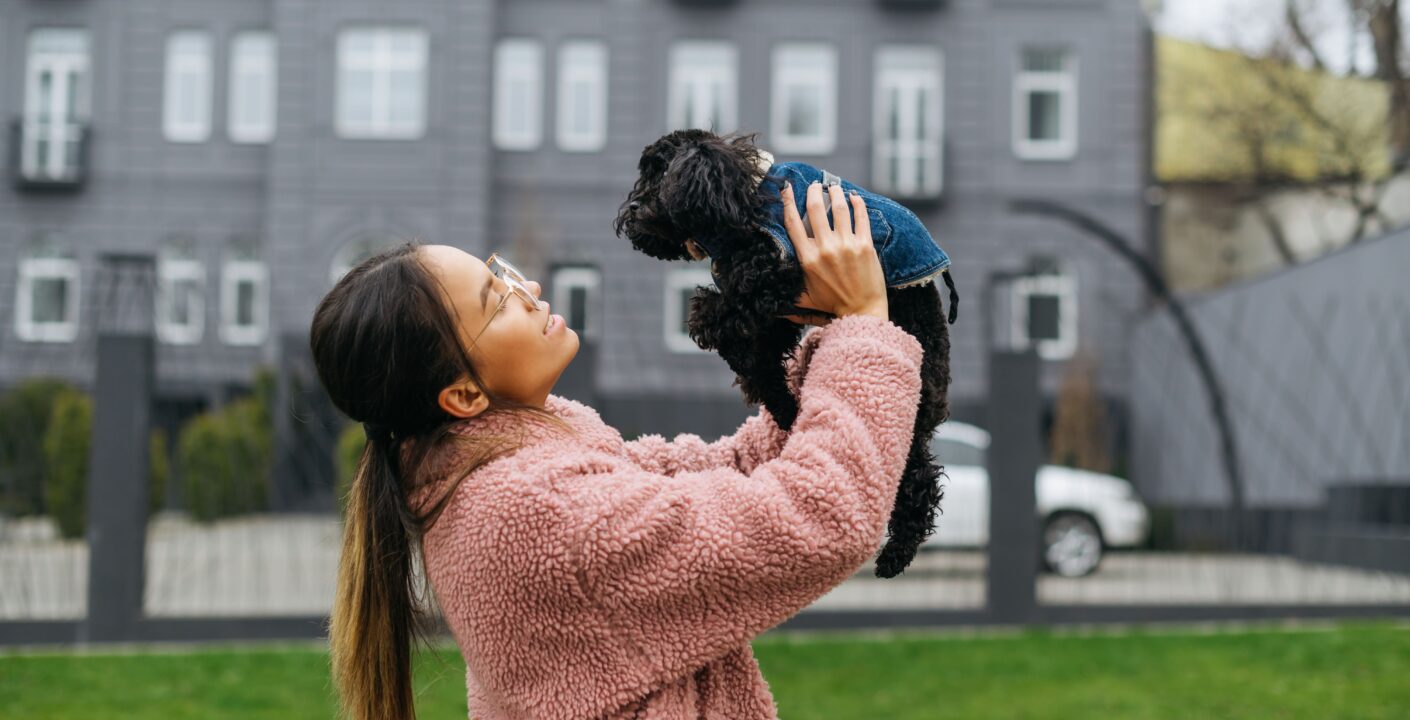 happy girl playing with dog outdoors spring cool day girl wearing pink coat doggy denim jacket () jpg