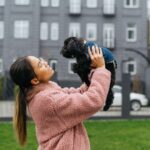 happy girl playing with dog outdoors spring cool day girl wearing pink coat doggy denim jacket () jpg