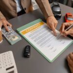 business meeting car dealer client discussing vehicle purchase agreement contract is being reviewed explained before signing representing trust cooperation